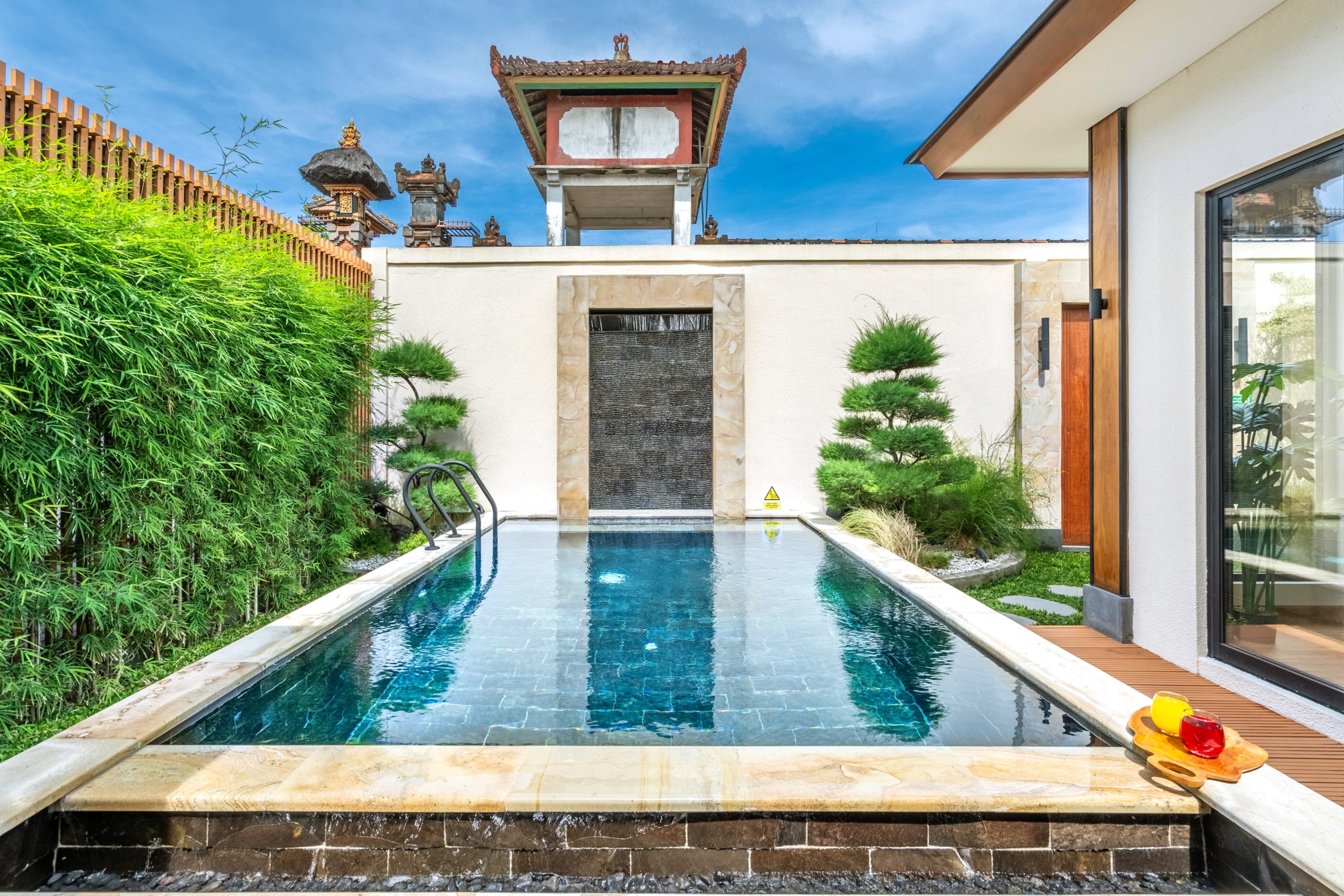 The pool by day, a neighbouring temple tower above the garden wall