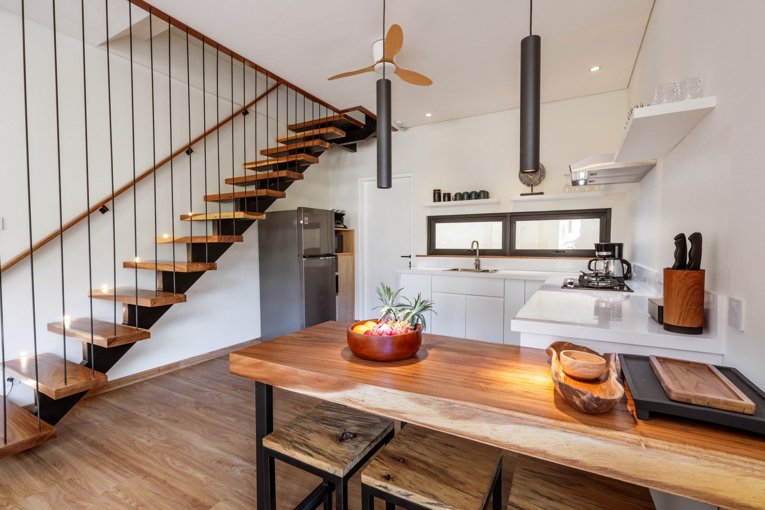 The floating stair, the kitchen and the teak island in one view