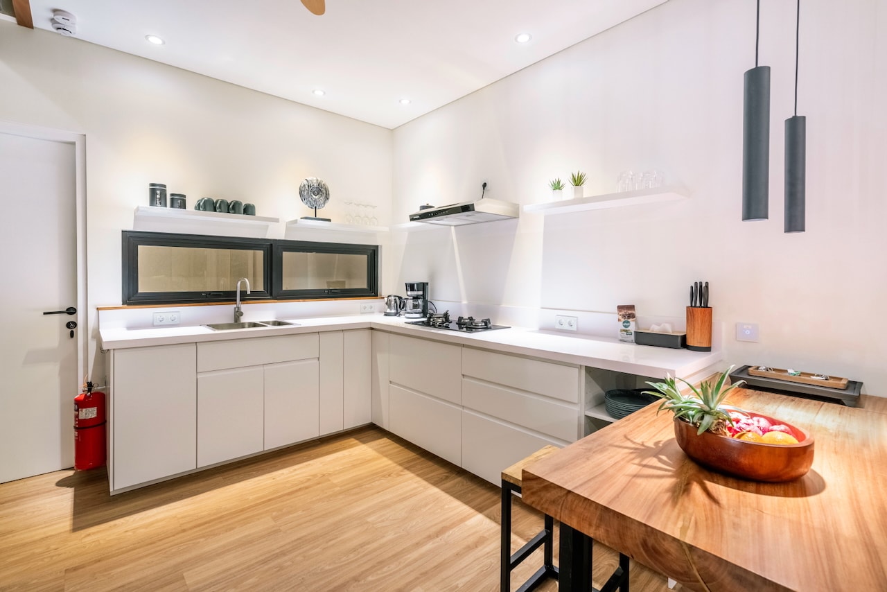 The teak kitchen island, the kitchen behind it