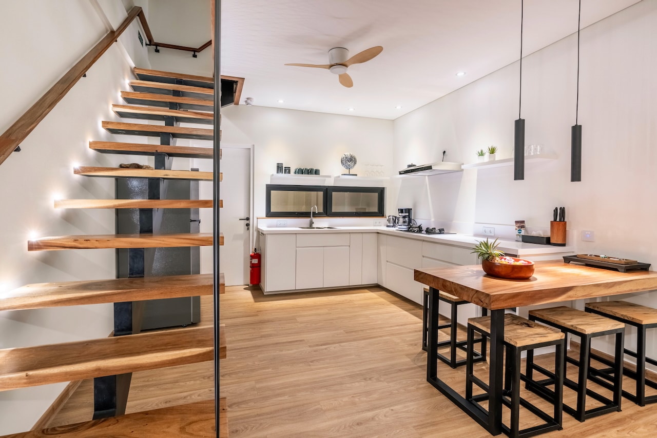 The kitchen and island beside the floating stair