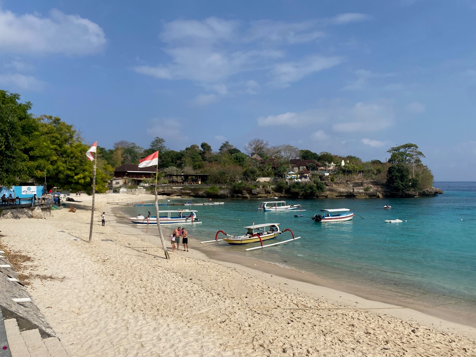 Mushroom Bay on Nusa Lembongan: a curved white-sand beach with boats moored in turquoise water
