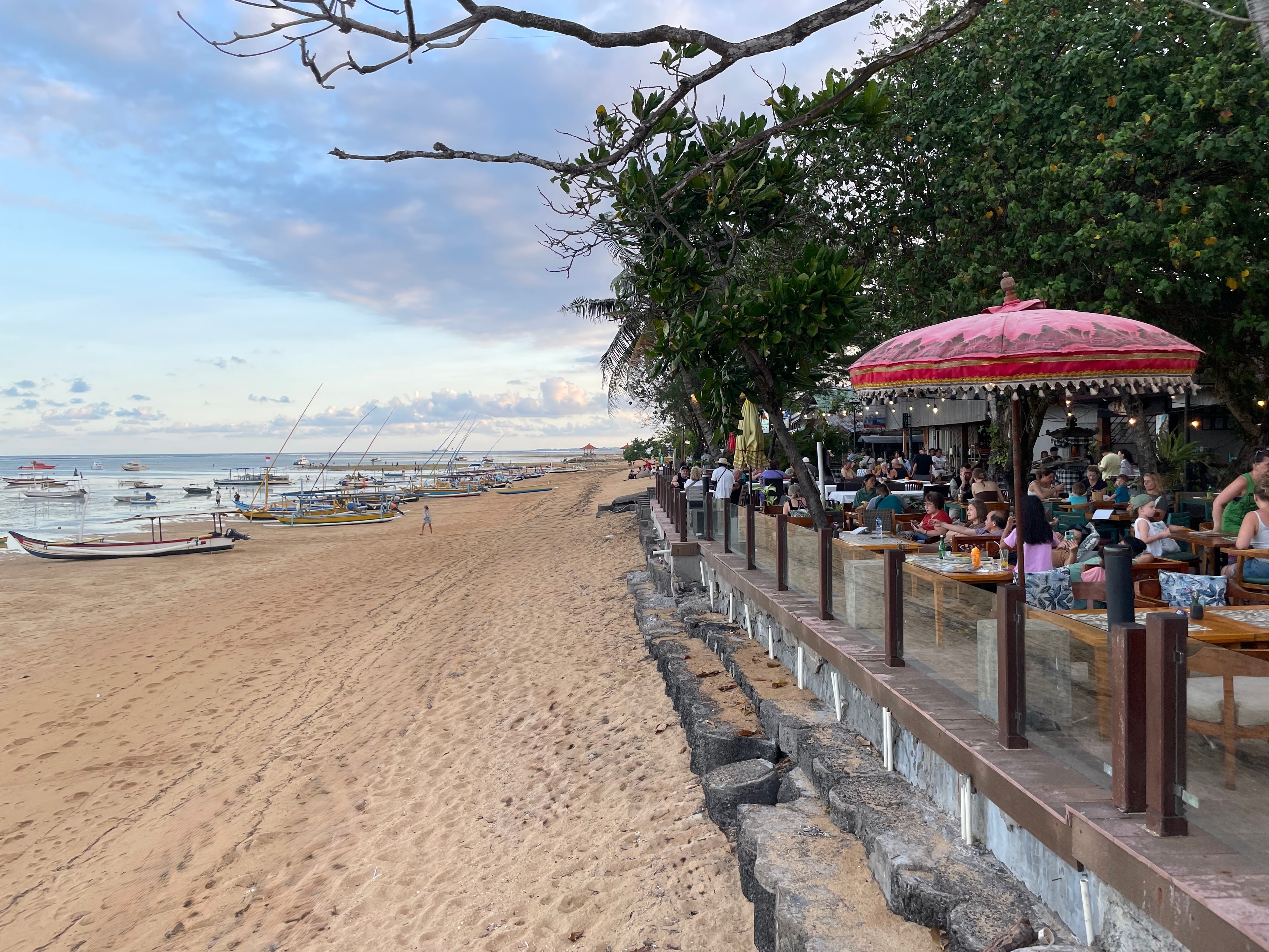 Beach cafés under red umbrellas